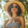 Woman wearing a gingham skirt and crop top with a straw hat - one of the best cute summer outfits for women for brunch or picnics.